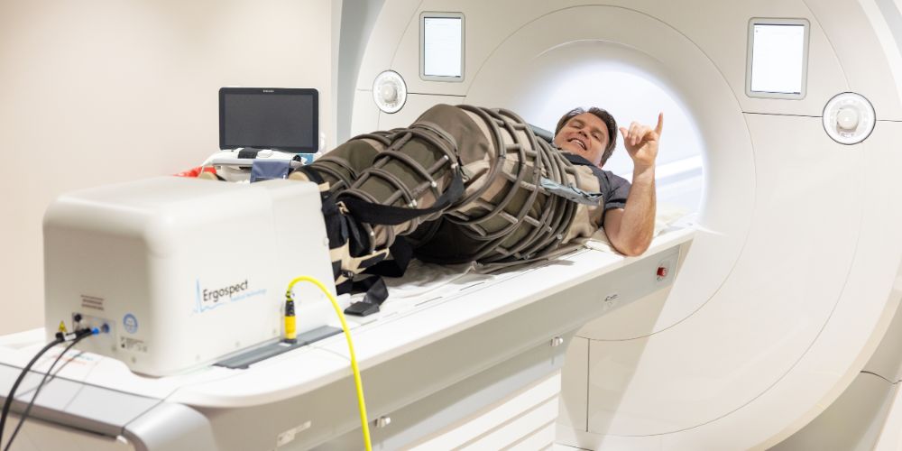 Michael Nelson, UTA researcher, wears lower body negative pressure pants inside an MRI