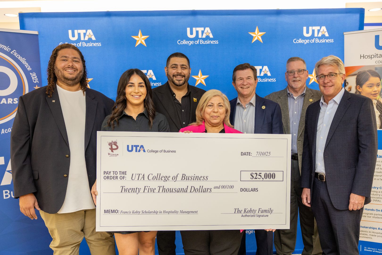 Image shows the Kobty family presenting their gift to the College of Business faculty 