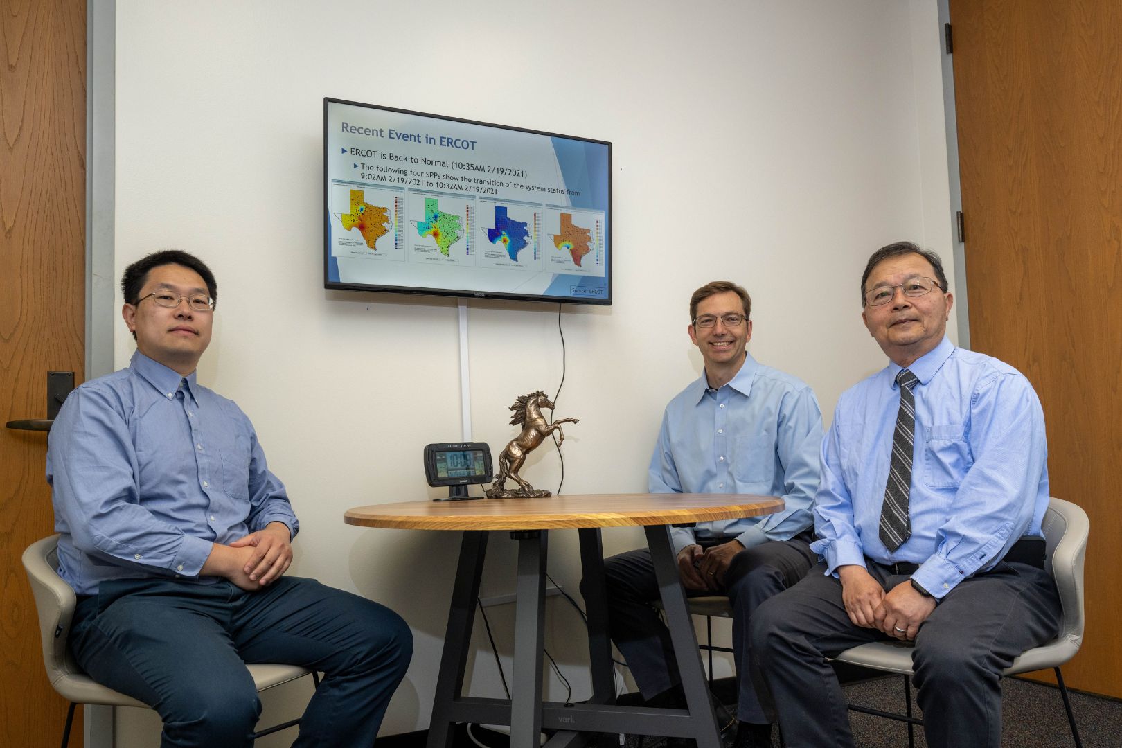 Image shows Dr. Yichen Zhang sitting on the left side of the photo