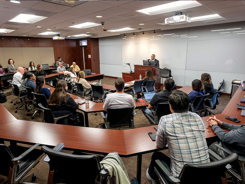 Students listening to a professor in a lecture hall