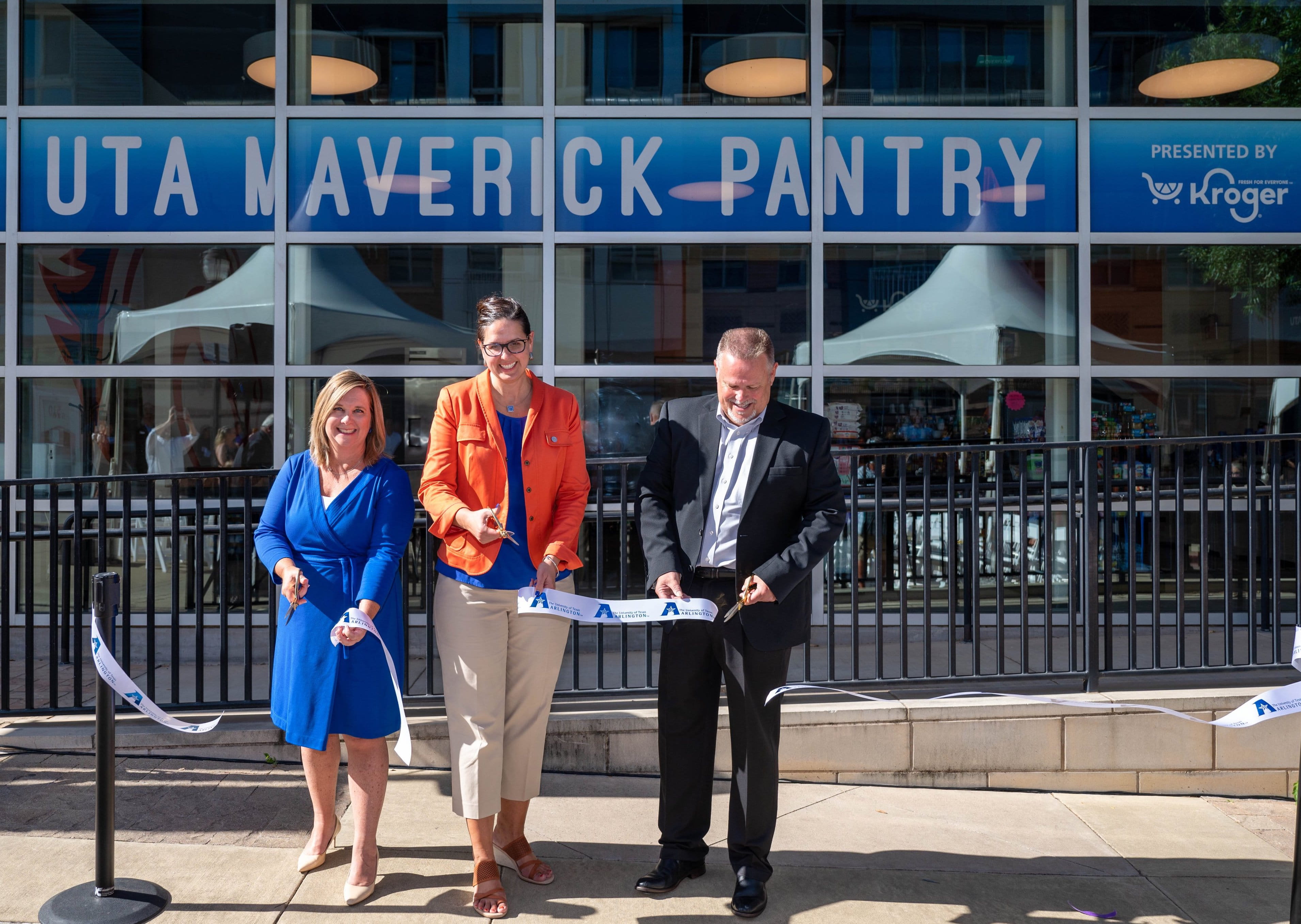 president cowley cutting the ribbon at the maverick food pantry event