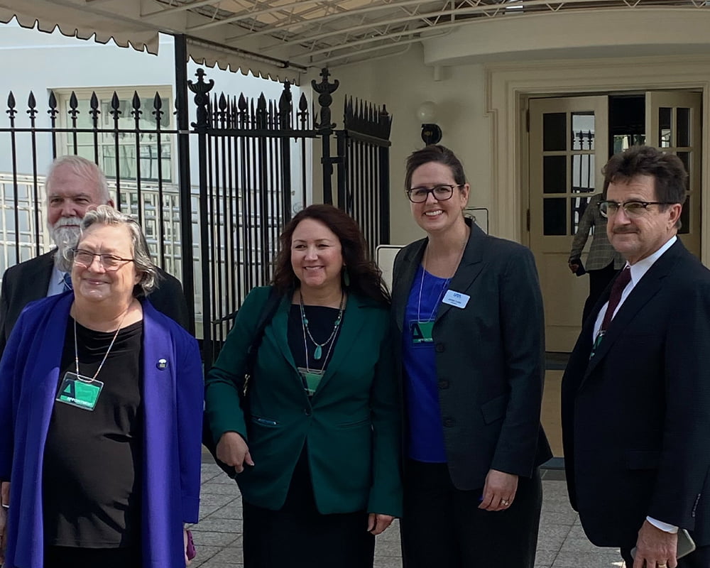 President Cowley poses for a photo with others in front of the Whitehouse