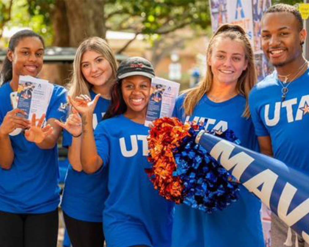 a group of UTA students wearing blue UTA shirts
