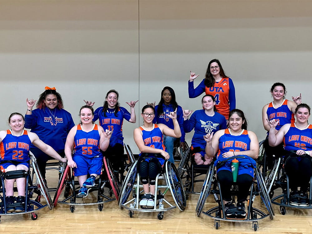 President Cowley with the Women's Movin Mavs wheelchair basketball team