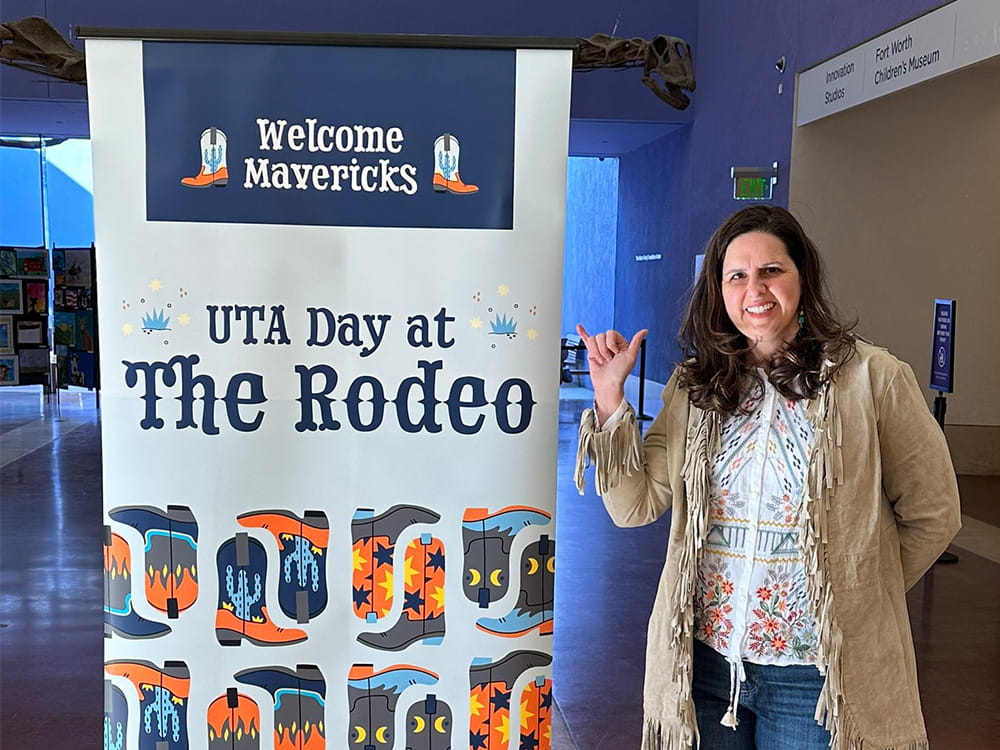 President Cowley at UTA Day at the Rodeo with banner