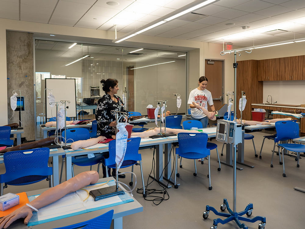 CONHI staff setting up equipment in new Smart Hospital classroom