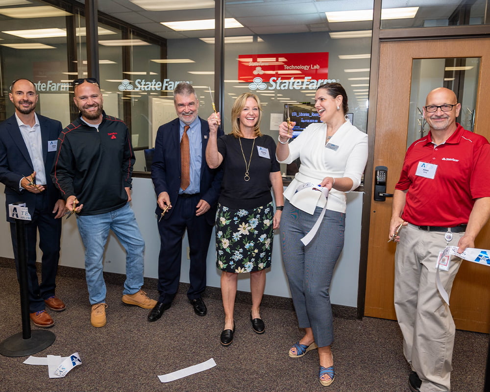President Cowley cutting ribbon at State Farm Technology Lab opening