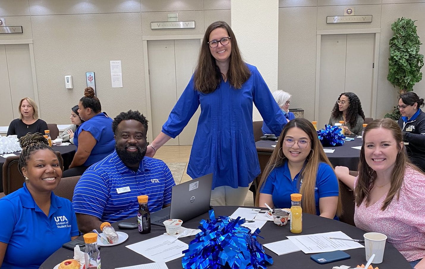 president cowley at a breakfast table with UTA's student success team