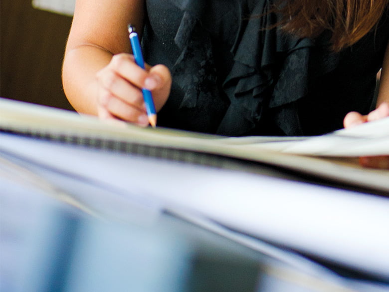 Woman holding pencil and paper