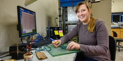 A student works on an electrical board.