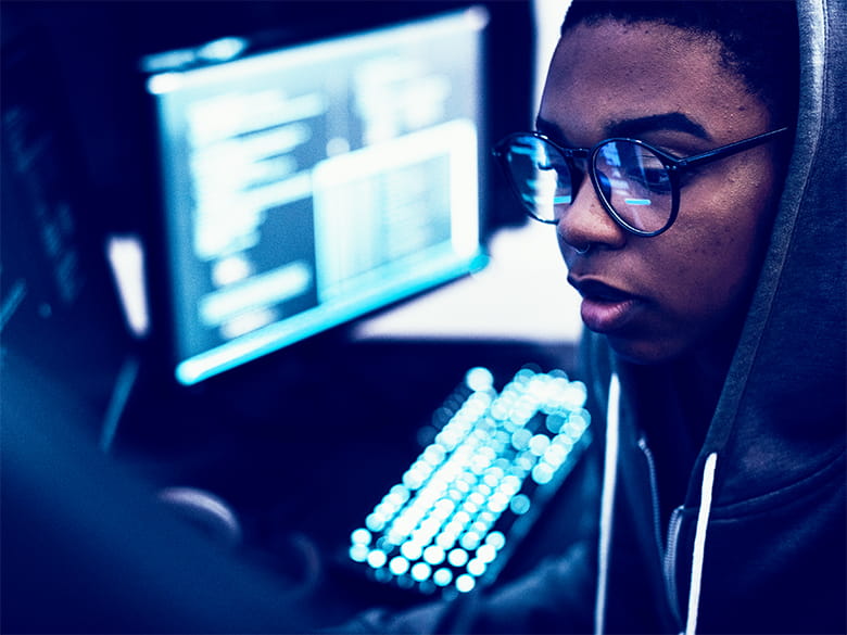 A male student looks at a computer screen.