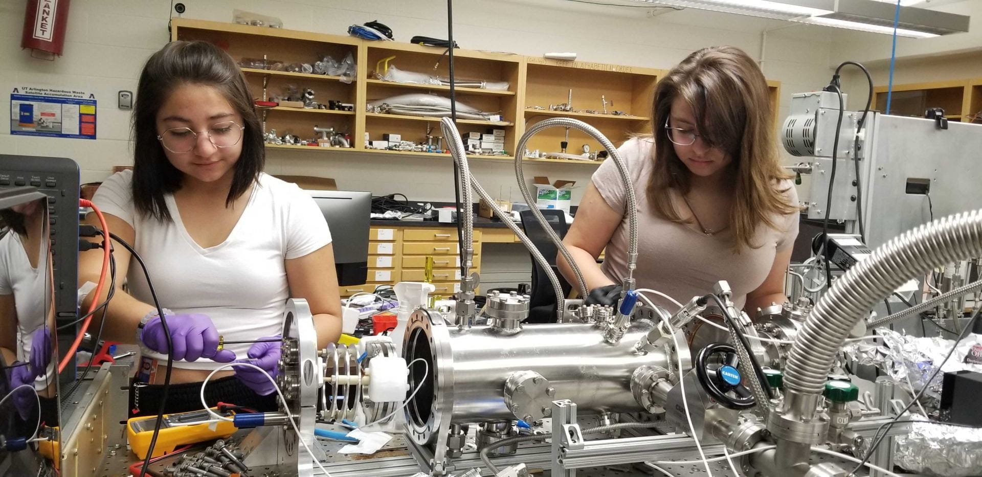 A pair of students work on equipment in a Physics Lab