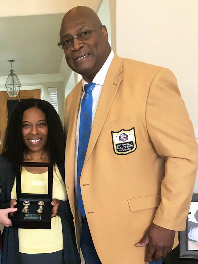 Maya Herzog with Pro Football Hall of Famer Charles Haley after Haley surprised her at home with the news that she was named a Ford Hall of Heroes award recipient. Photo courtesy of Maya Herzog