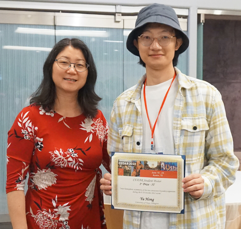 Yue Deng, left, and Yu Hong, with his first-place poster award