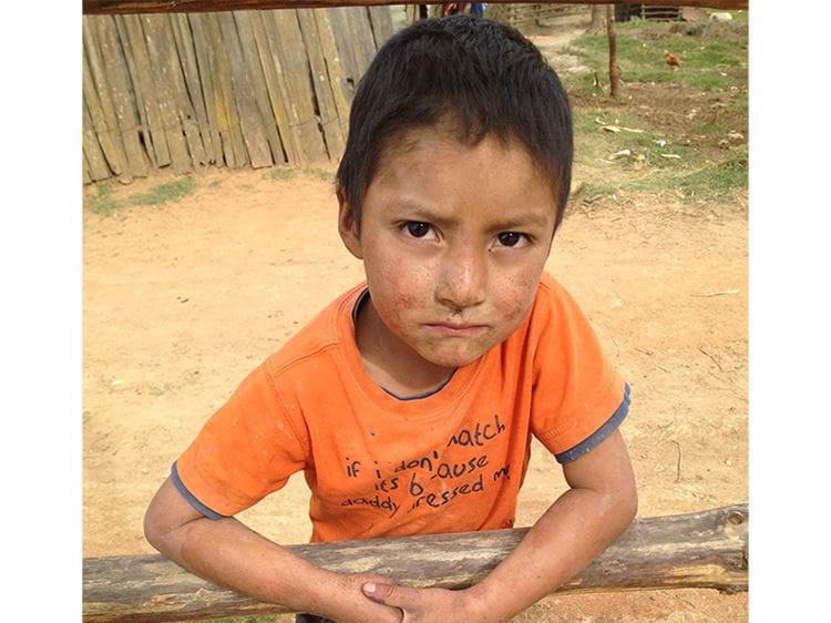 Picture of a Guatemala kid in an orange shirt.