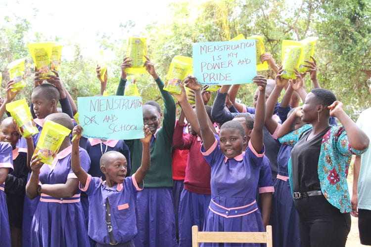 Kenya students holding Menstruation signs up during study abroad trip to Kenya