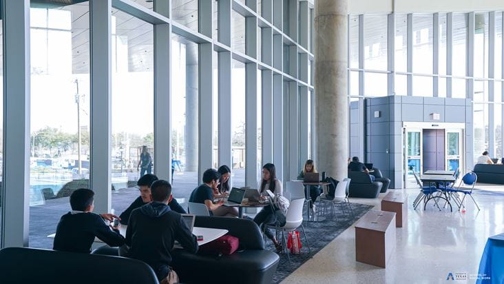 UTA students sitting in lobby during open house