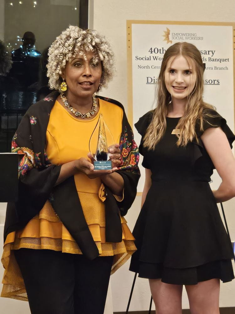 UTA School of Social Work PhD Alumna, Pamela Fox, on the left receive the Lifetime Achievement Award at the NASW Northeast Texas Banquet