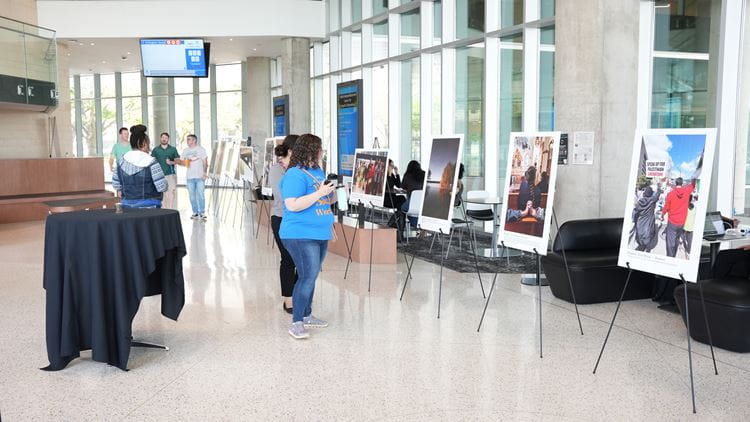 People viewing photos that were provide by students, faculty and staff for the Solar Eclipse campaign.