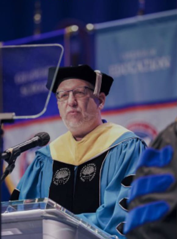 Dean Scott Ryan presenting at the Spring 2022 Commencement