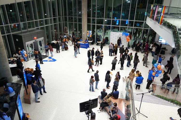 Photo of people gathering in the lobby of the School of Social Work and Smart Hospital building during  the Fall 2023 Celebration of Excellence