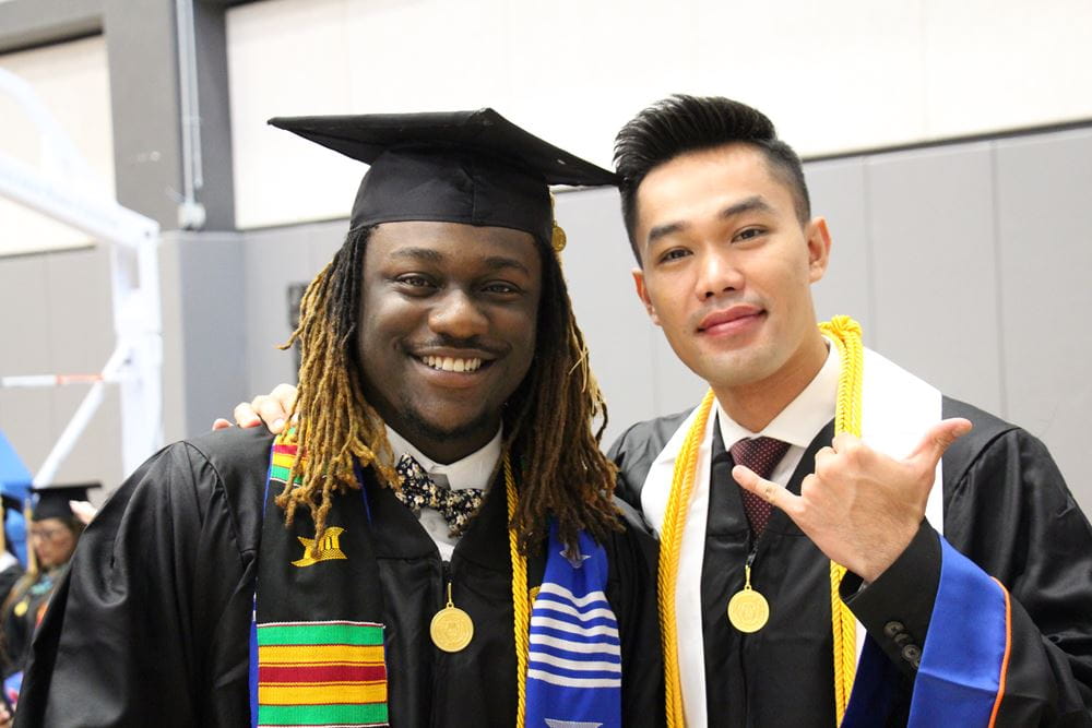 Two Students taking a graduation picture together
