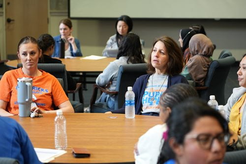 Student seated around table during an event