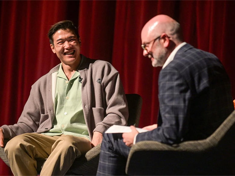 From left: Actor and comedian Joel Kim Booster and School of Social Work Dean, Kirk Foster
