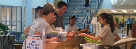 Student employee checking in a group of students at the MAC