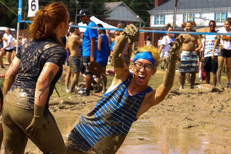 Student throwing up mud in the air excitedly
