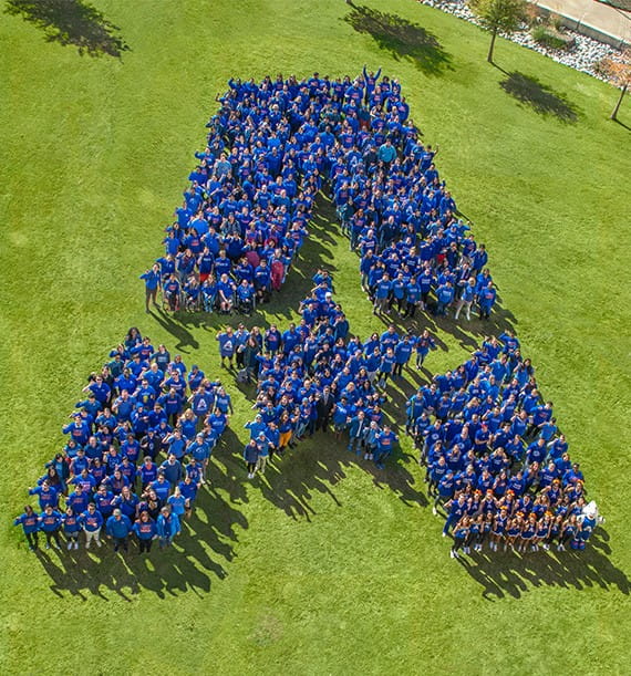 group of people gathered to form the UTA logo
