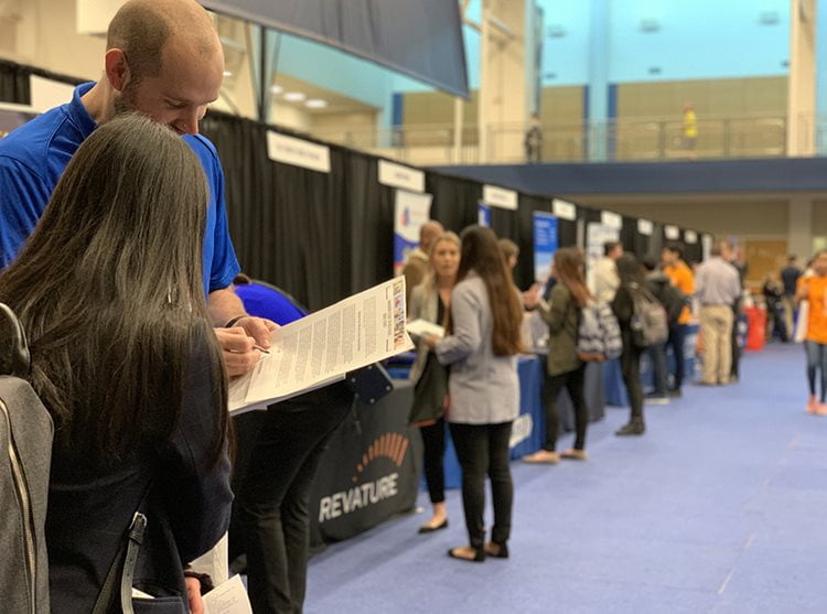 people talking at job booths