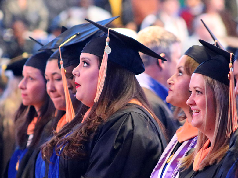 Students at graduation with gowns and caps