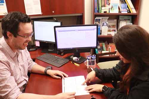 Adviser speaking with a student in his office