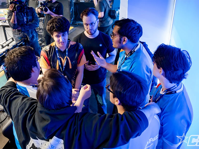 Esports team members gathered in a circle talking