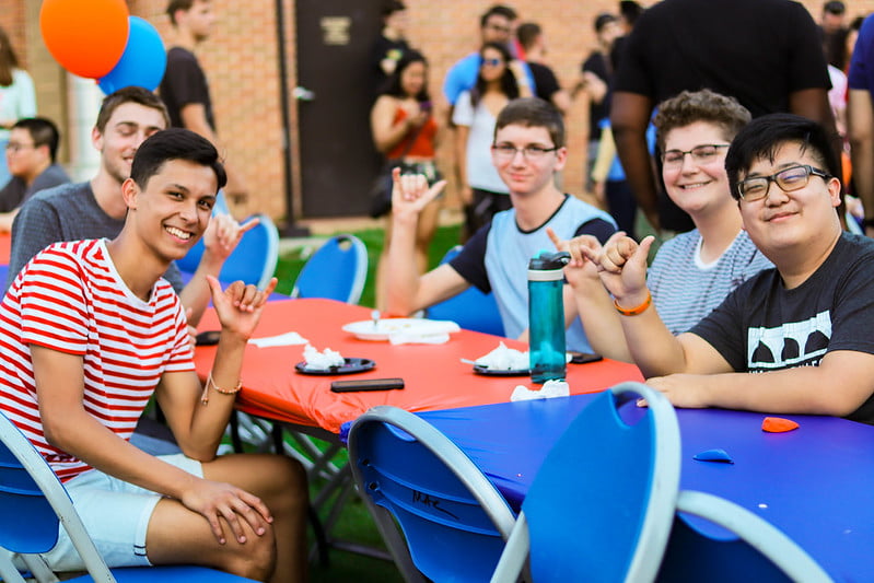 Five friends at a table Maving up at Waffleopolis