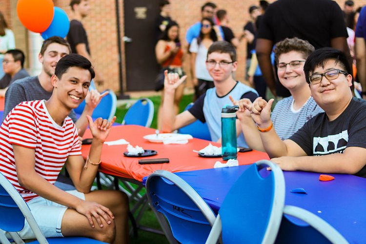 Five friends at a table Maving up at Waffleopolis