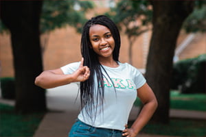 An alpha kappa alpha member doing their sign