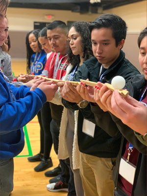 F&SL members playing a game of balance with a small ball