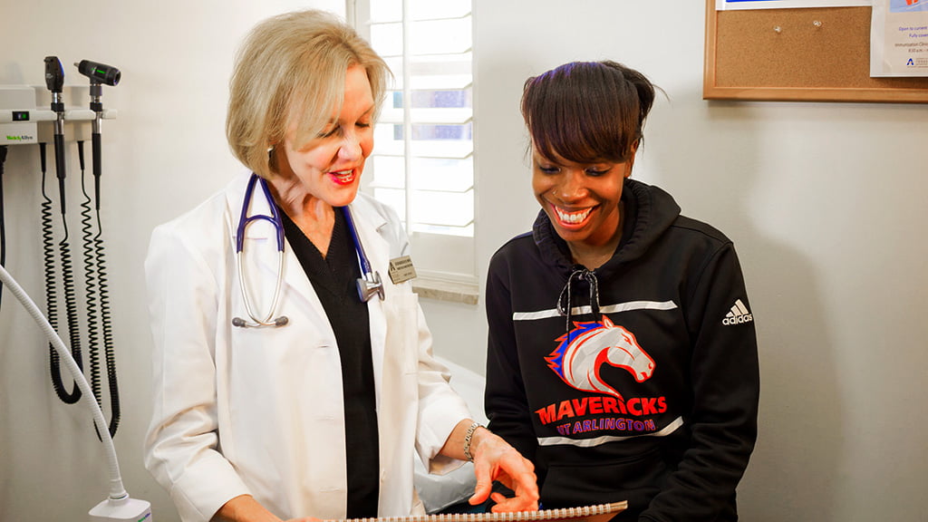 Patient with a doctor reading a report