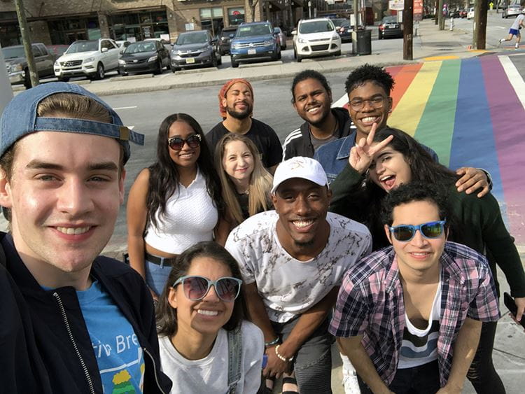 Alternative Breaks group on a sidewalk with rainbow colors
