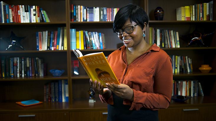 A student reading a book at the Leadership library