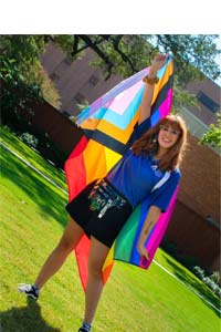 Student raising flag in air above her head