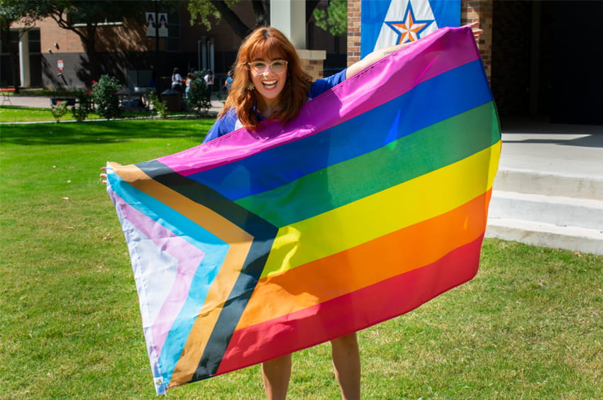 Student holding up LGBTQA flag.