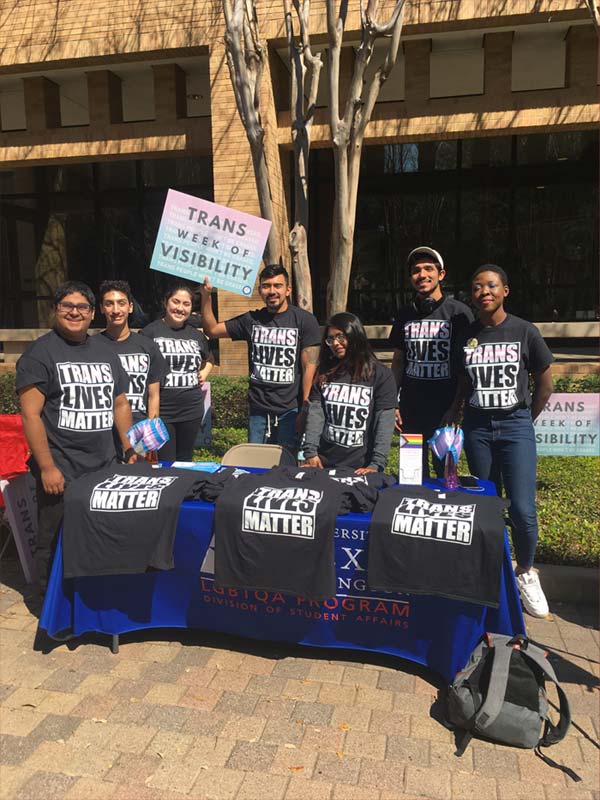 7 people, wearing black shirts, tabling for Trans Lives Matter in front of the University Center