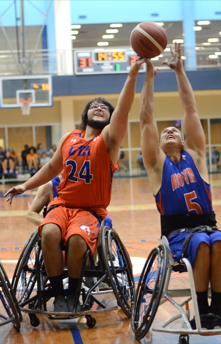 Two movin mavs players reach up for the basketball