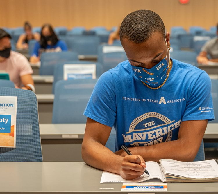 student sitting masked in the classroom