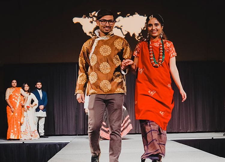 students walking on stage for international week