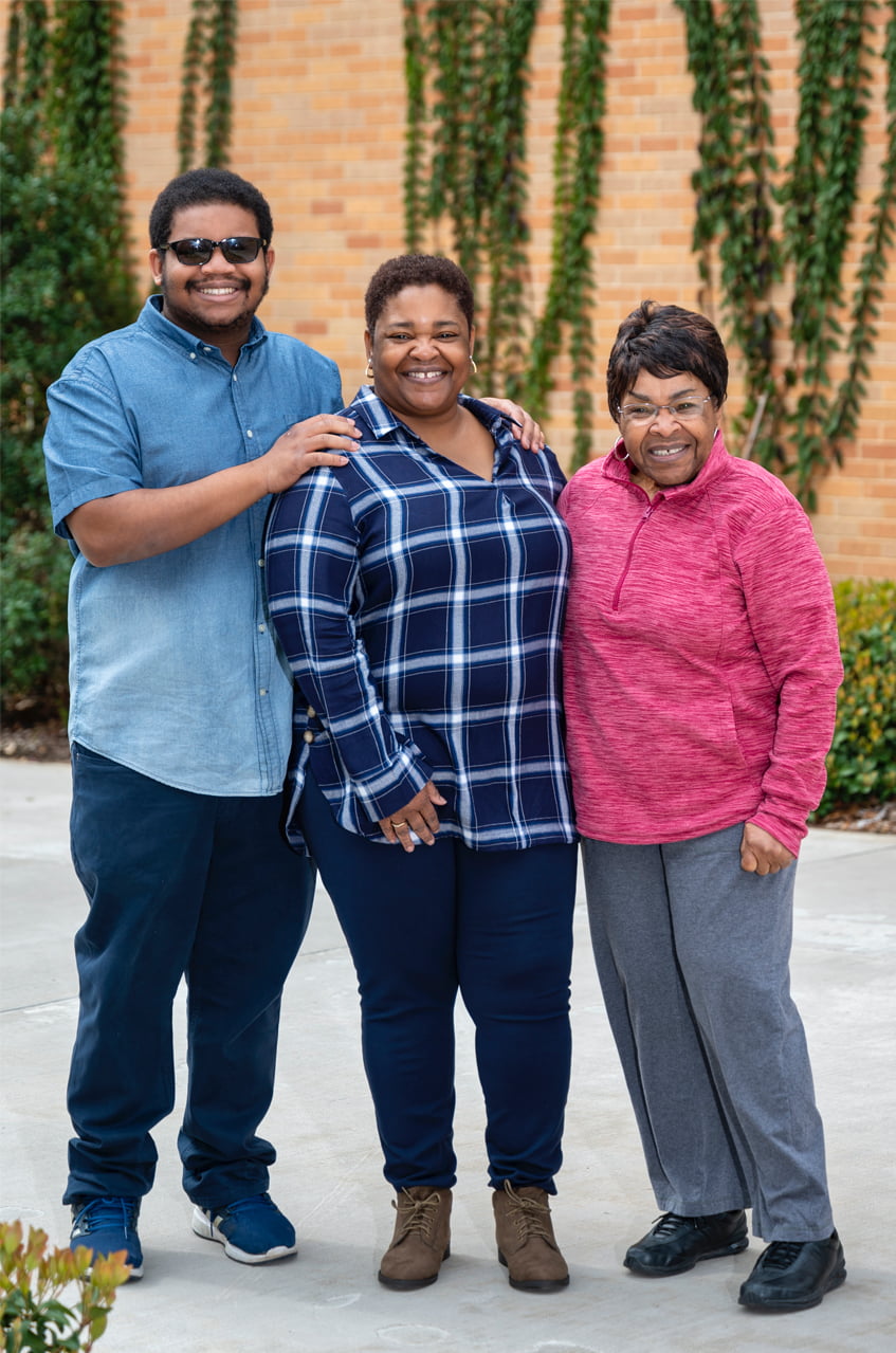 A young man with his mom and grandma.