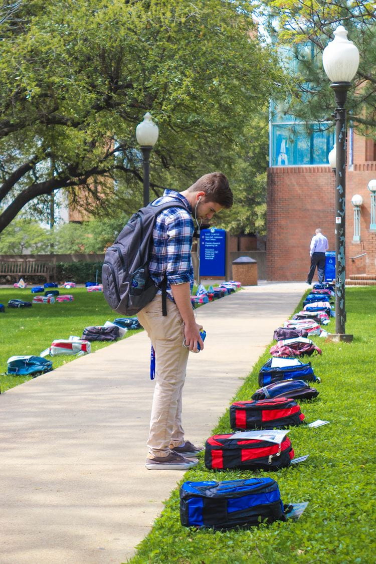 A UTA student observing the Send Silence Packing Campaign at UTA 